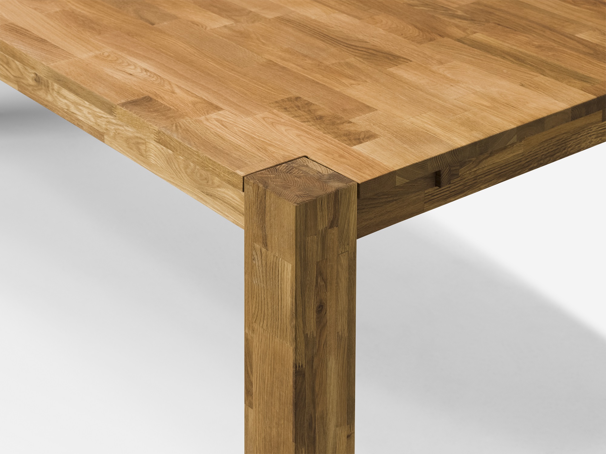 Detail view of large oak Harvest rustic dining table