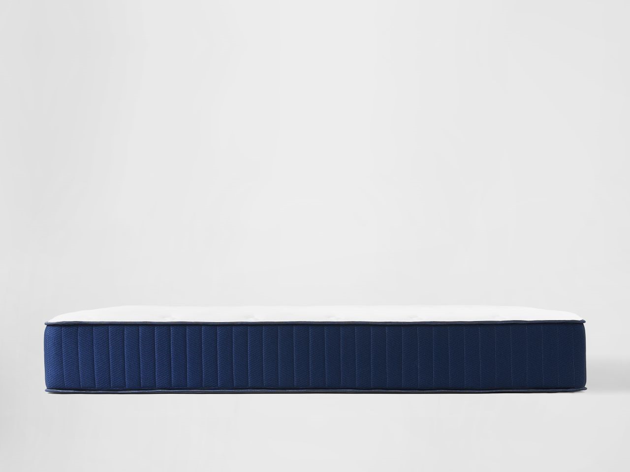 Hybrid firm mattress with blue sides and white top side view