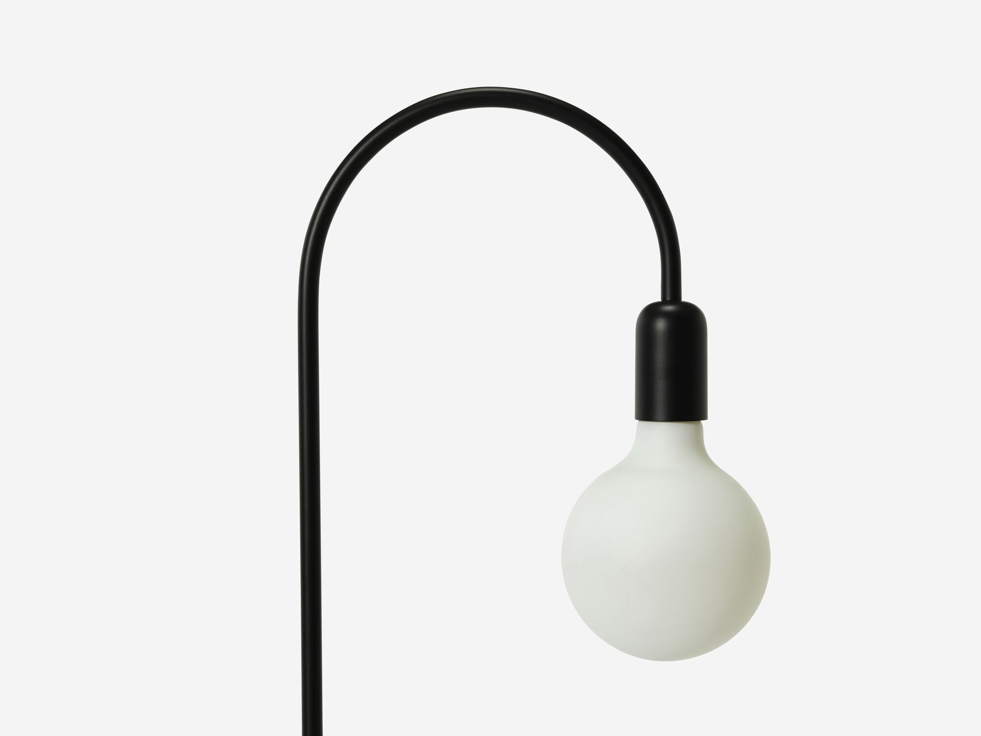 Detail bulb view of black arched floor lamp