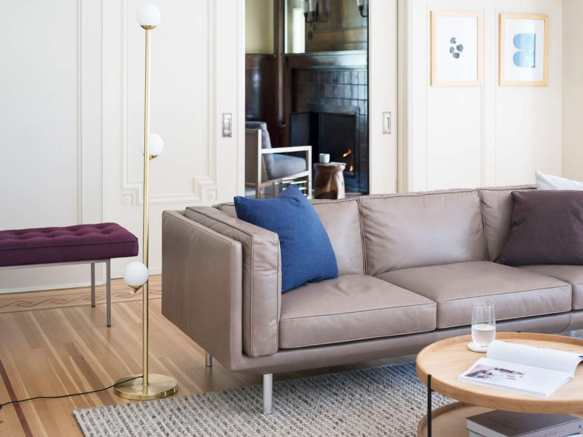 Brass floor lamp beside gray leather couch in living room