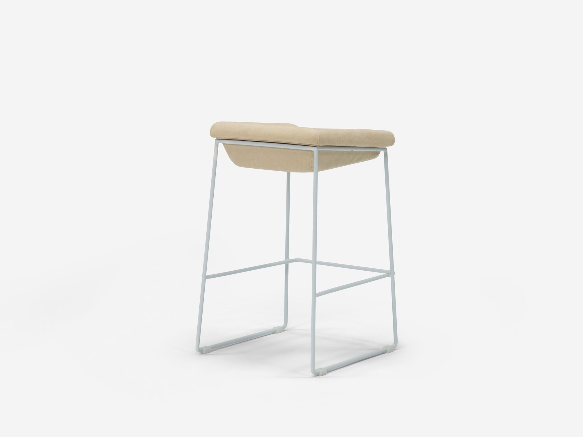 Counter stool with beige seat and white legs back angle view