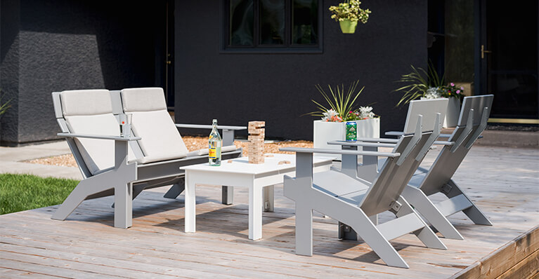 Loll designs outdoor grey lounge chairs are shown in on a wooden deck. Link to Loll design category