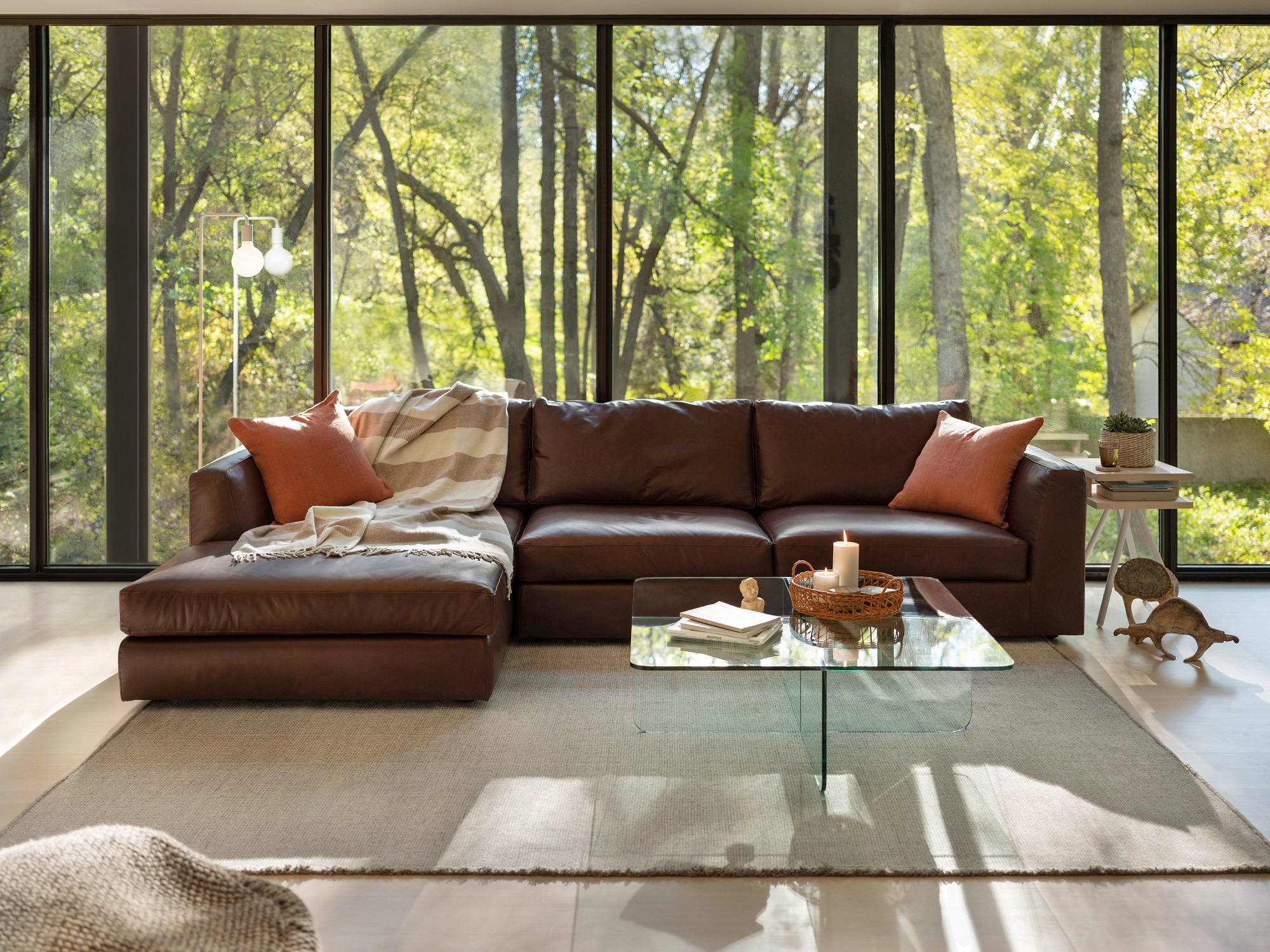 Brown leather sectional in huge, bright living space