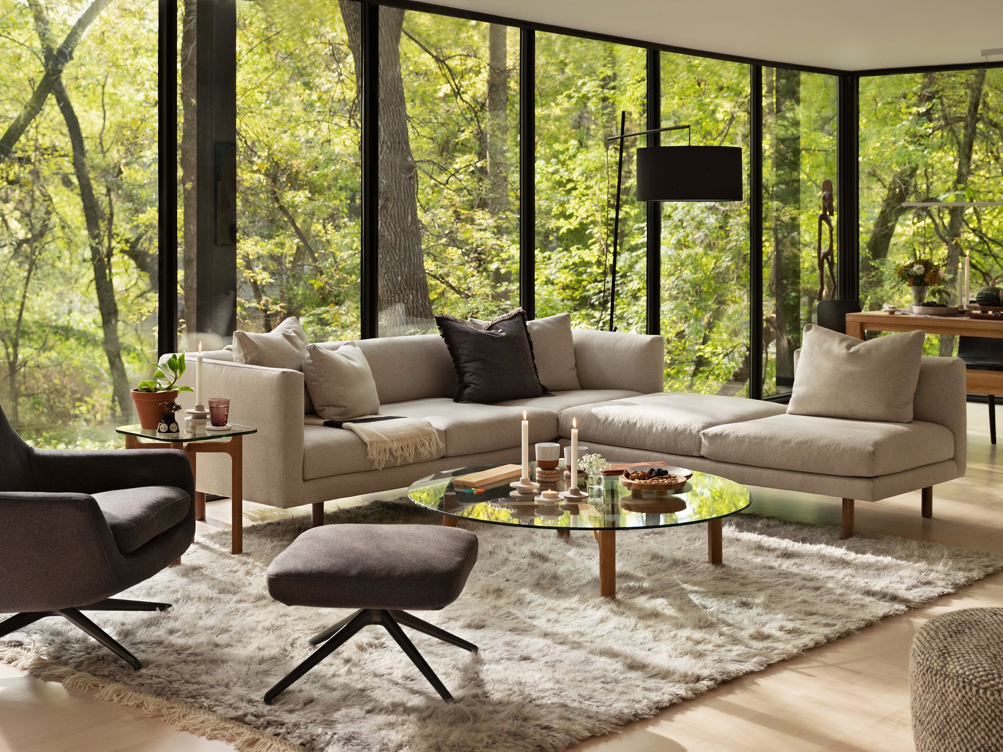 The Replay modern sectional sofa with backless chaise in beige with the Place glass coffee table in an open concept living room