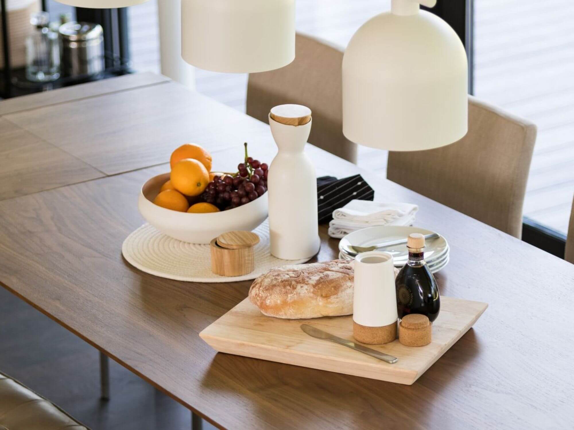 White stoneware milk jug and other dishes on a modern dining table