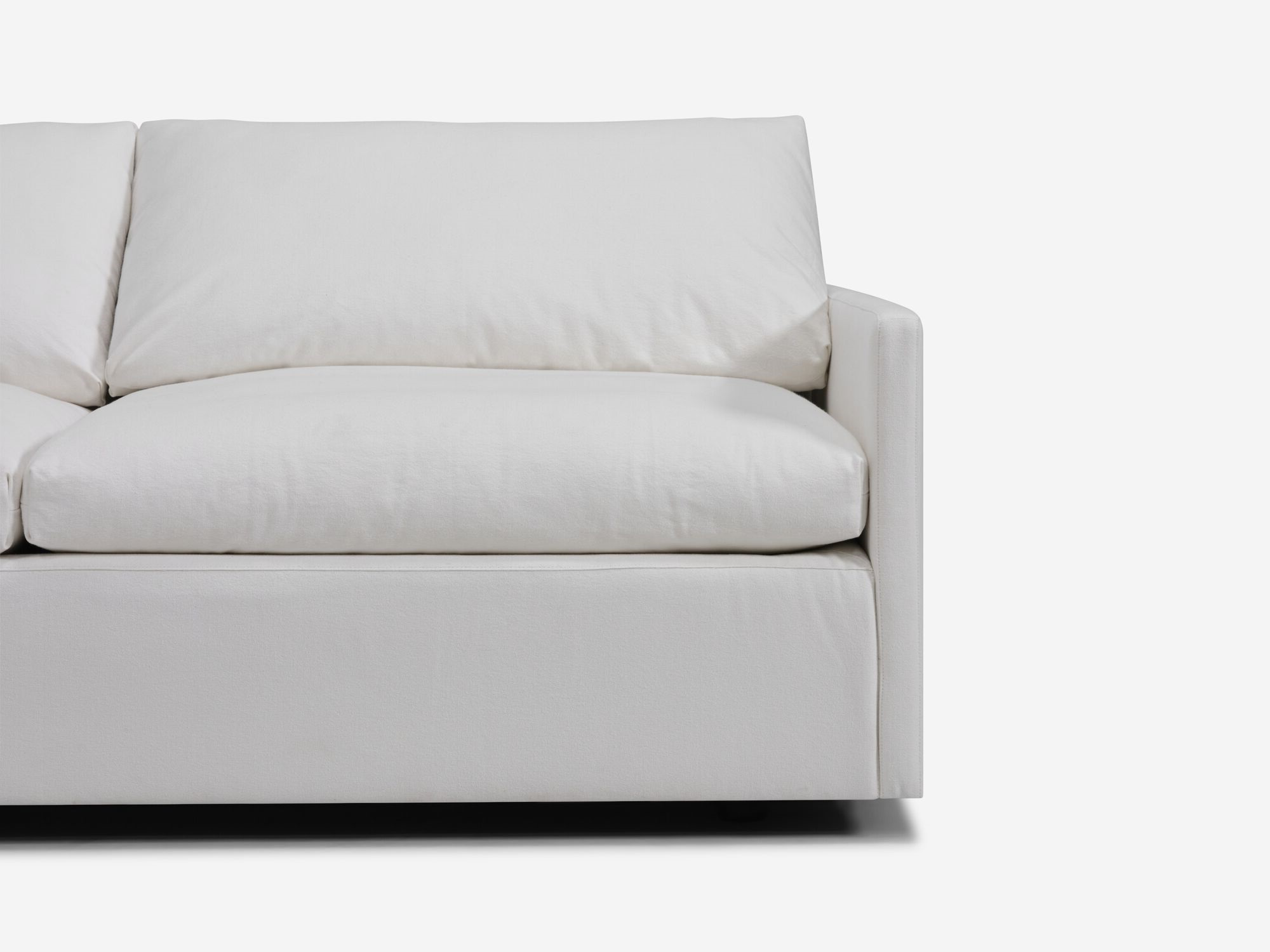 Seat detail view of white sectional sofa with narrow arms