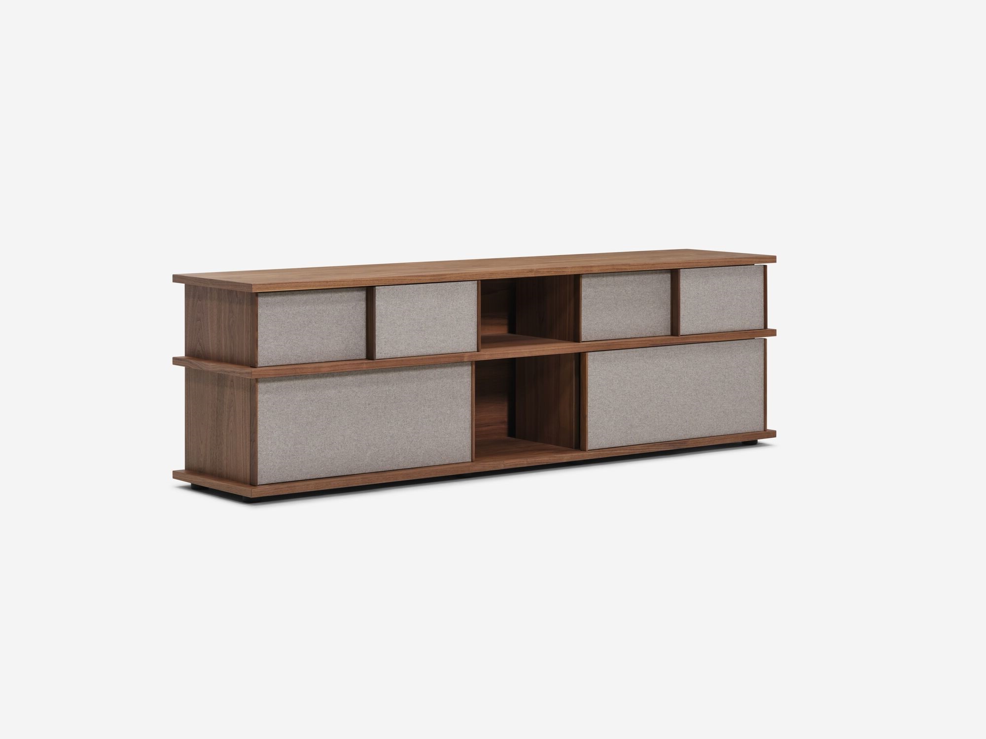 Angled view of the Plank tall modern media console in walnut with closed drawers and fabric panels