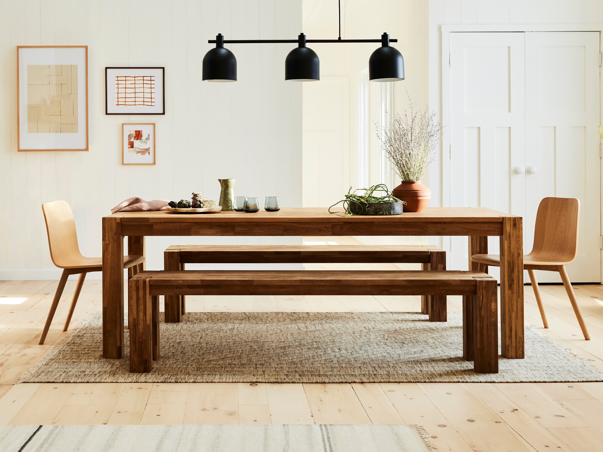 Modern rustic dining table with matching benches and chairs in modern dining room