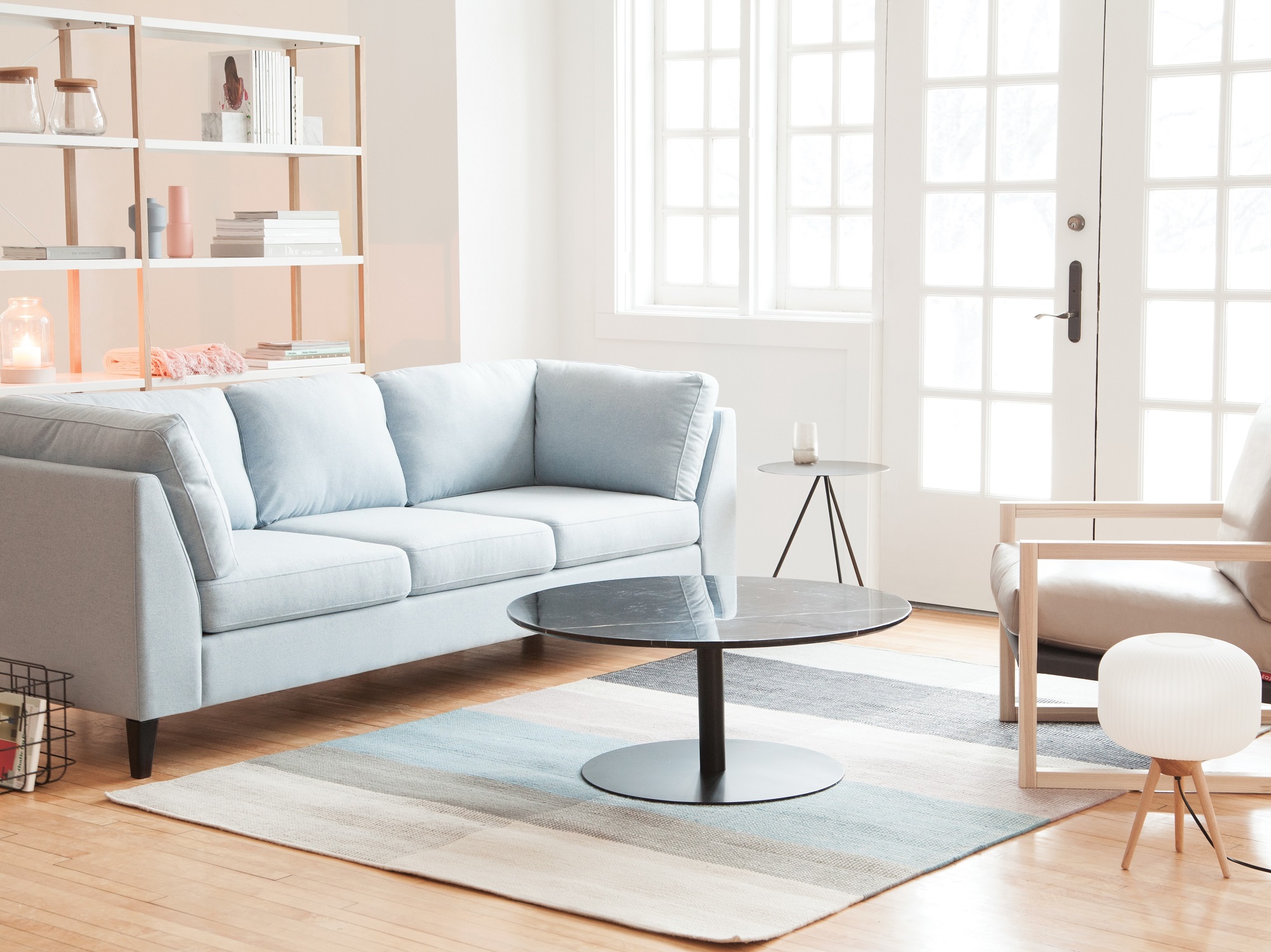 Light grey modern boho couch in living room with french doors