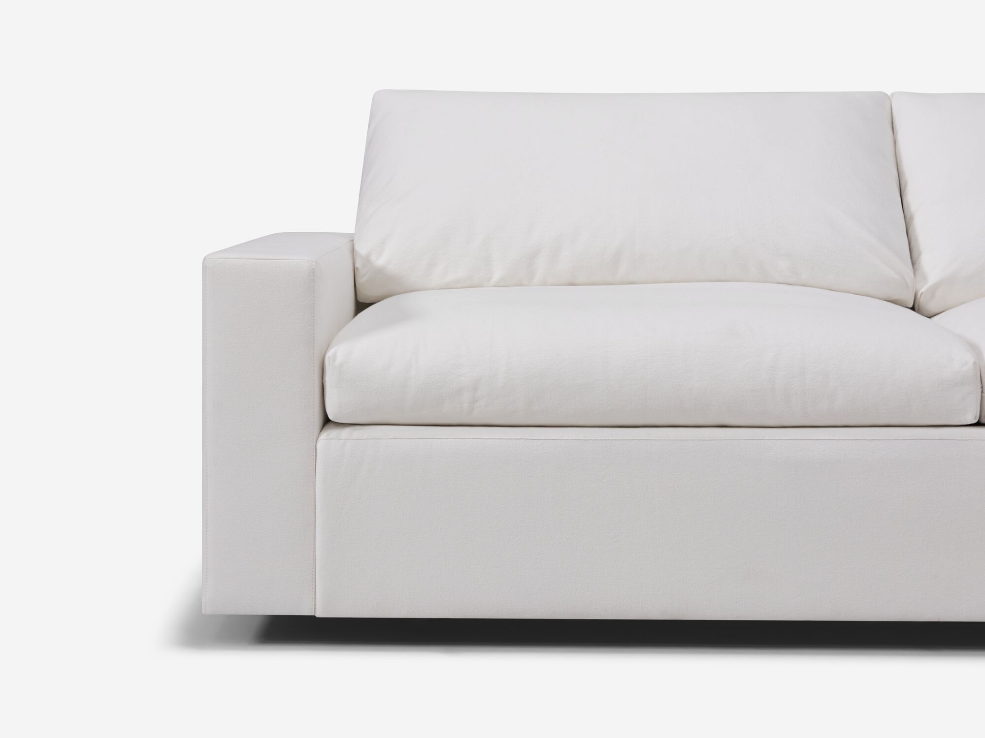 Detail view of white sectional sofa with right hand chaise