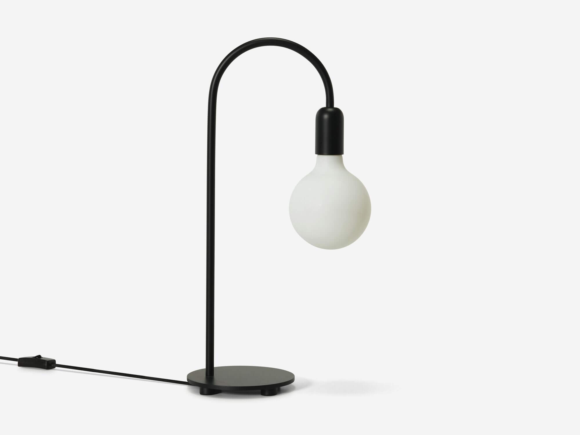 Side view of black curved table lamp