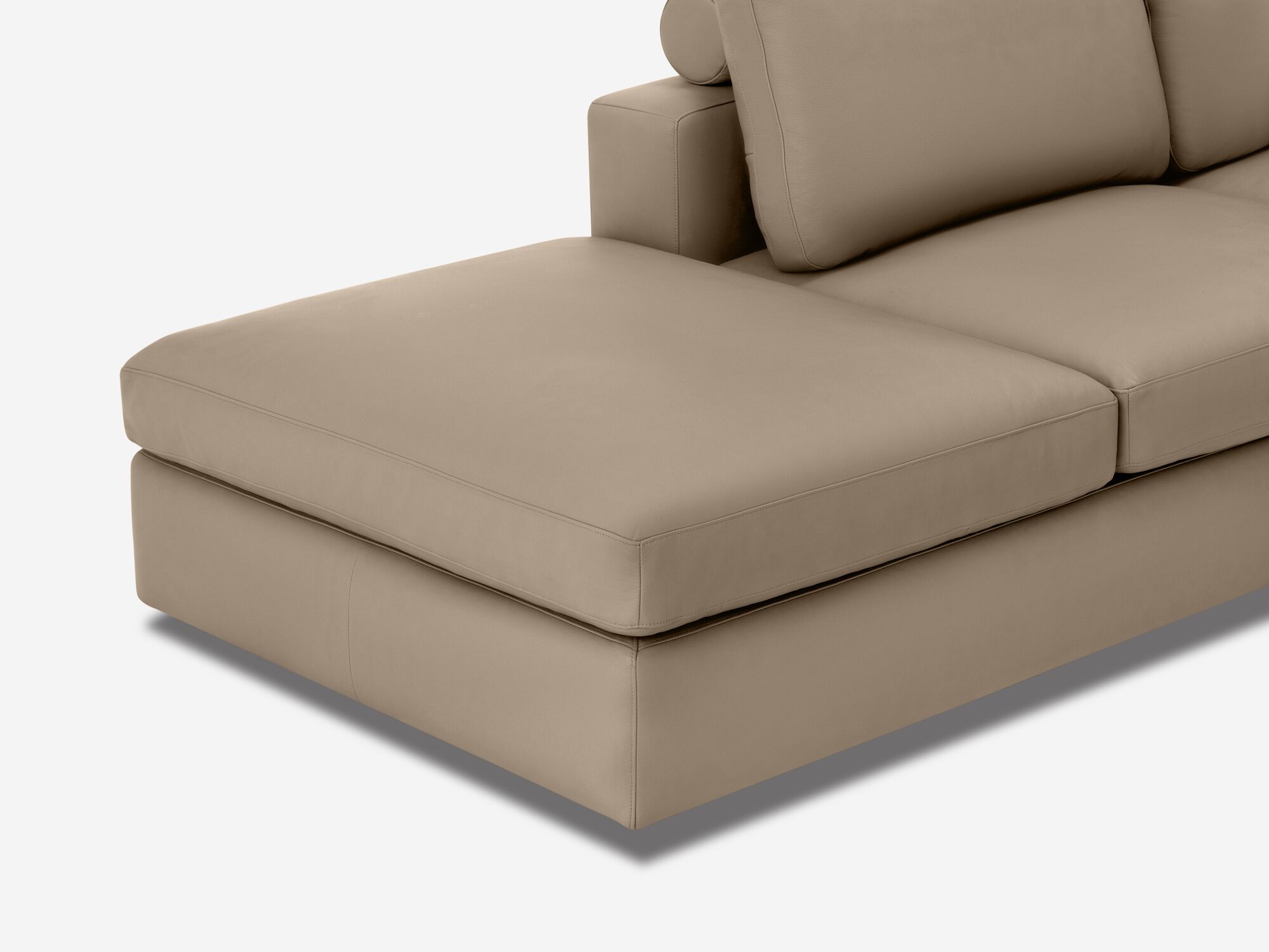 Chaise detail view of taupe leather sectional sofa