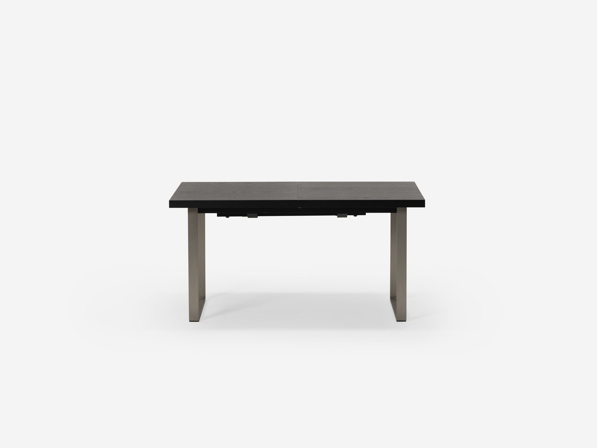 Expandable dining table with stainless steel legs and black top side view