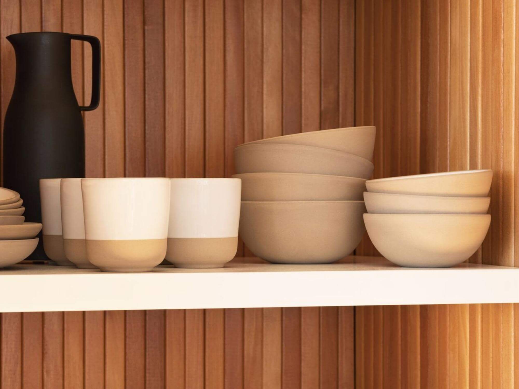 Small white stoneware bowls on pantry shelf with matching dishes