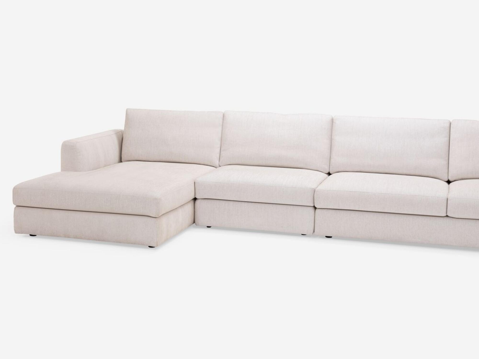 Detailed view of the modern sectional couch in white fabric with left hand chaise