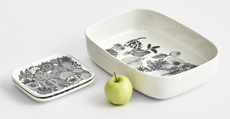 white tableware with a marimekko motif is displayed on a table top. Link to marimekko category