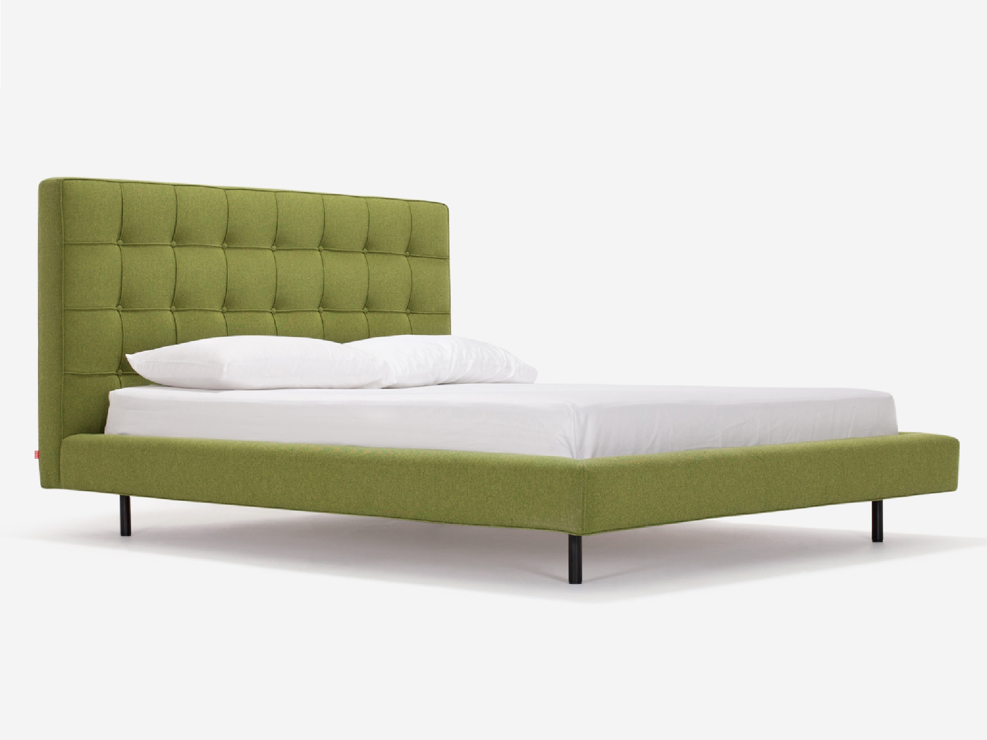 Corner view of Winston, the mid century modern bed, in green fabric with a high headboard