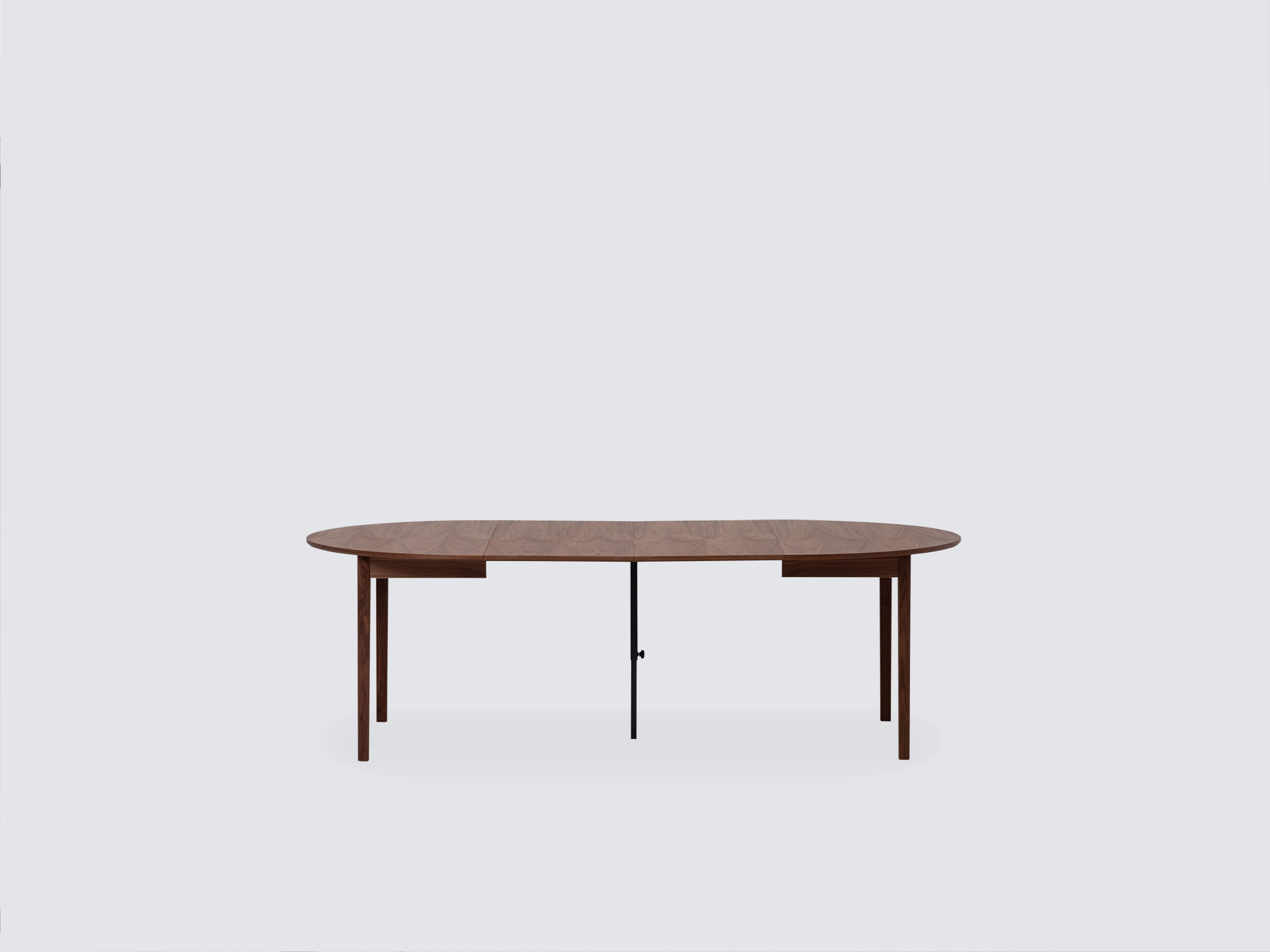 Side view of the small expanded Ease Expandable Dining Table in walnut