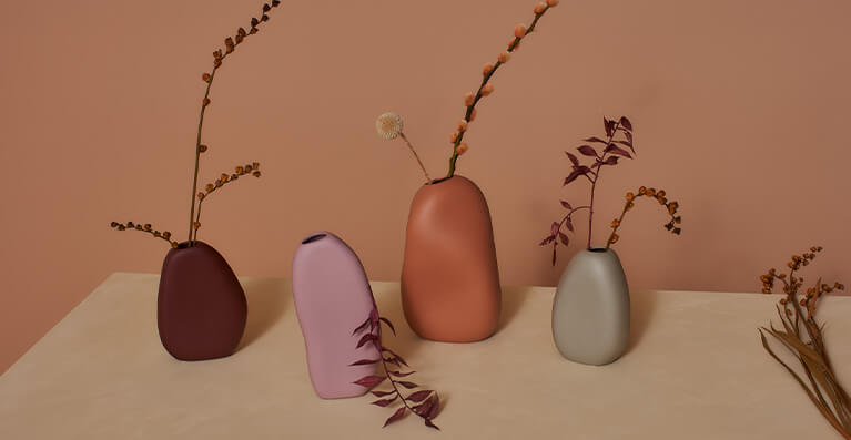 Various size vases are displayed on a beige shelf. Link to pebble vases