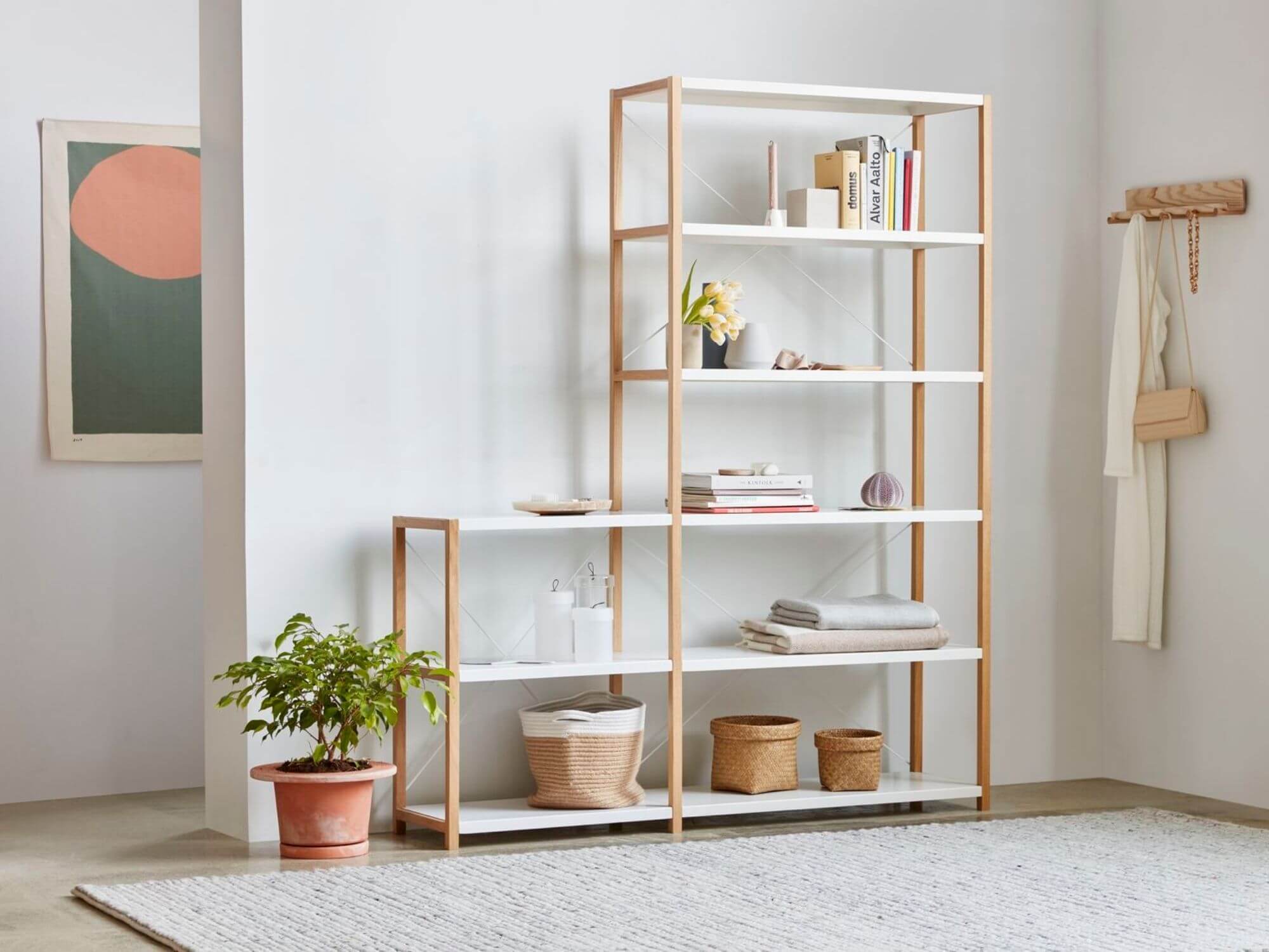 White and beige storage basket on bottom of open shelves