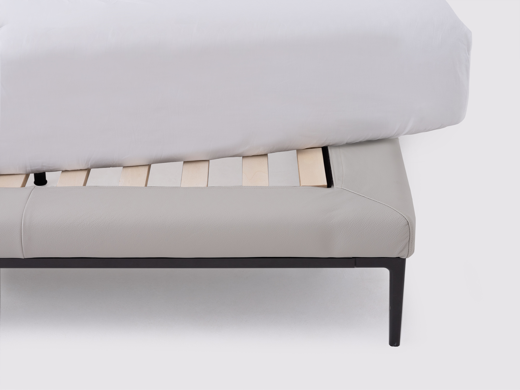 Slats detail view of the Oma modern upholstered bed in grey leather