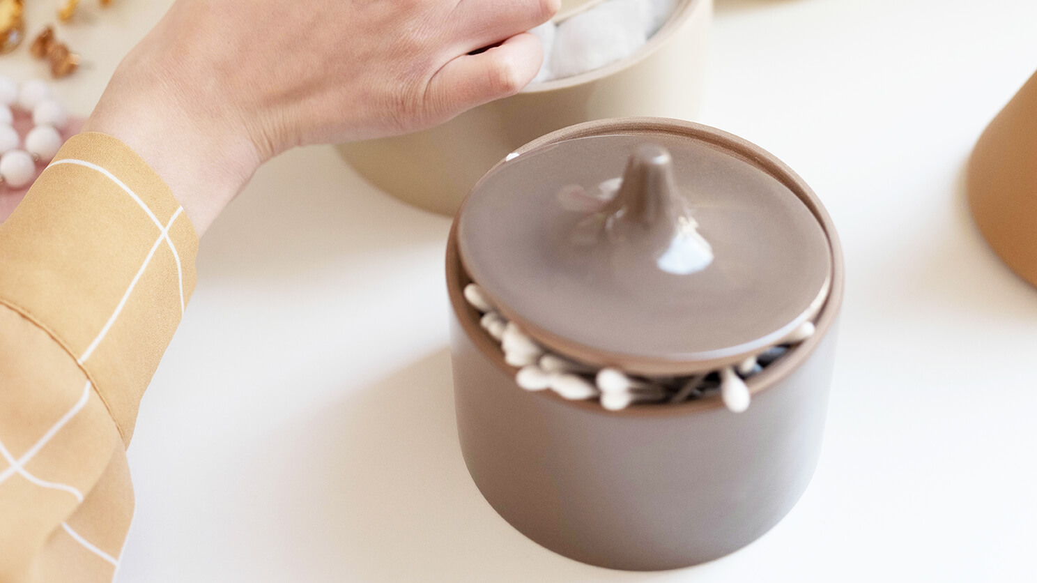 Beige ceramic containers on vanity table 