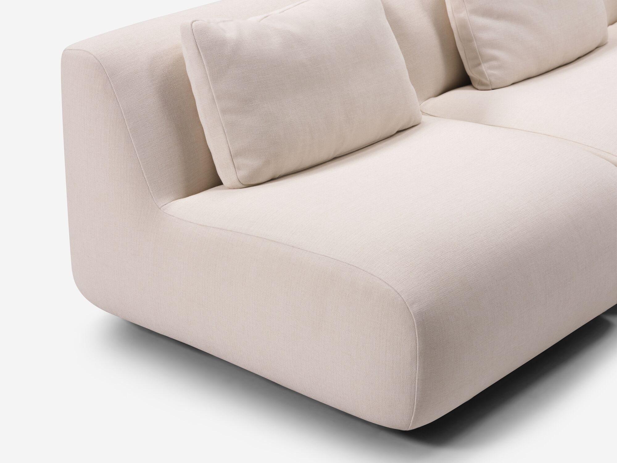 Beige curved sectional seat detail view