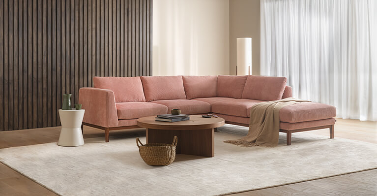 Pink modern sectional sofa is shown in a large living room. Link to sectional sofa category