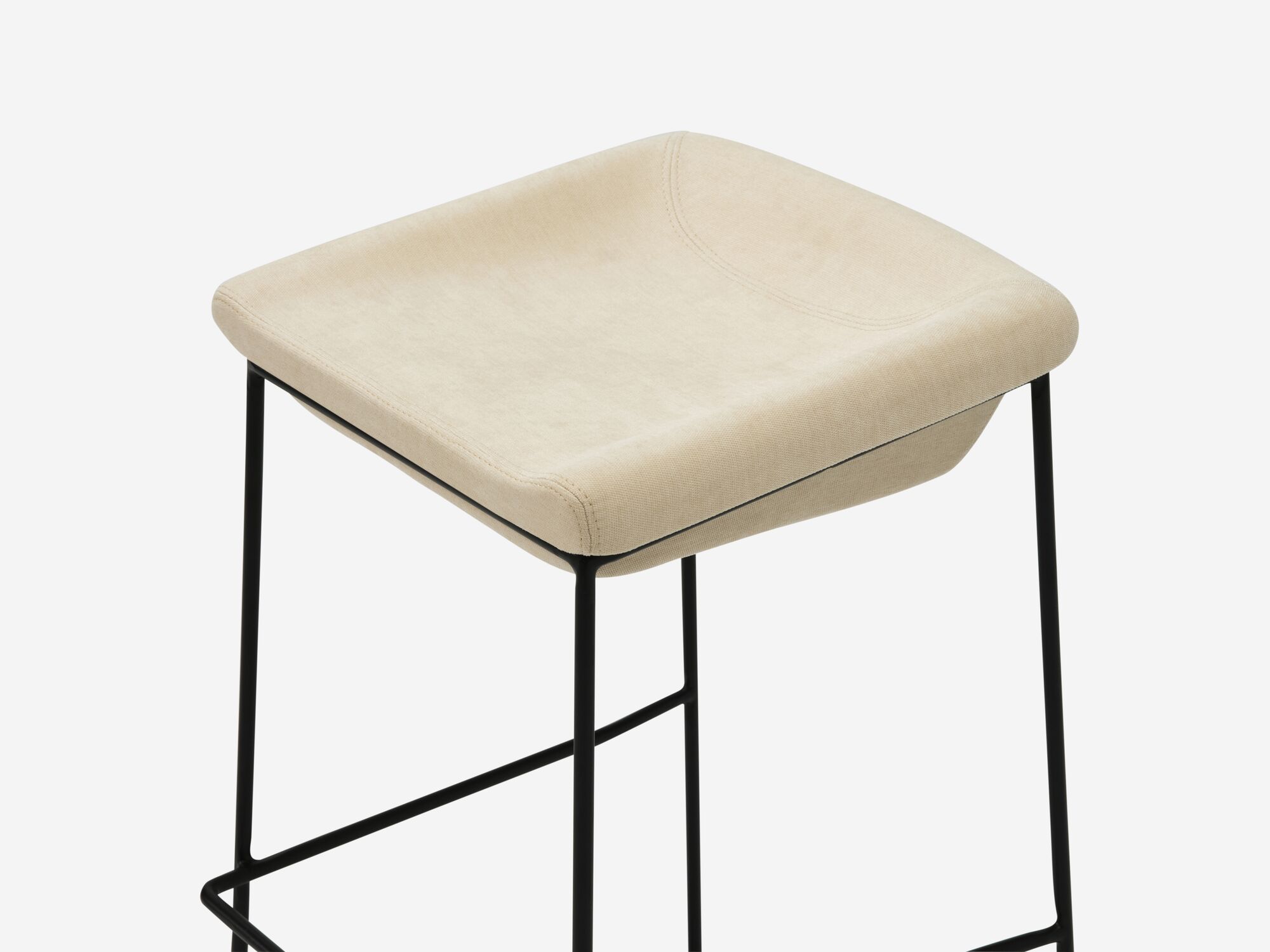 Counter stool with beige seat and black legs detail view