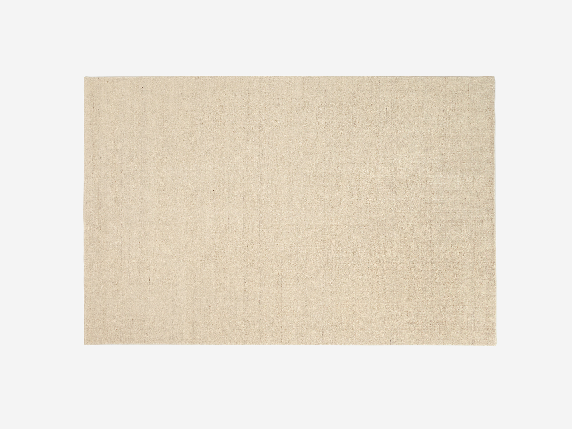 Top view of handmade area rug in cream