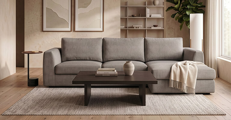 A grey fabric sectional sofa is shown in a modern living room. Link to ready to ship category