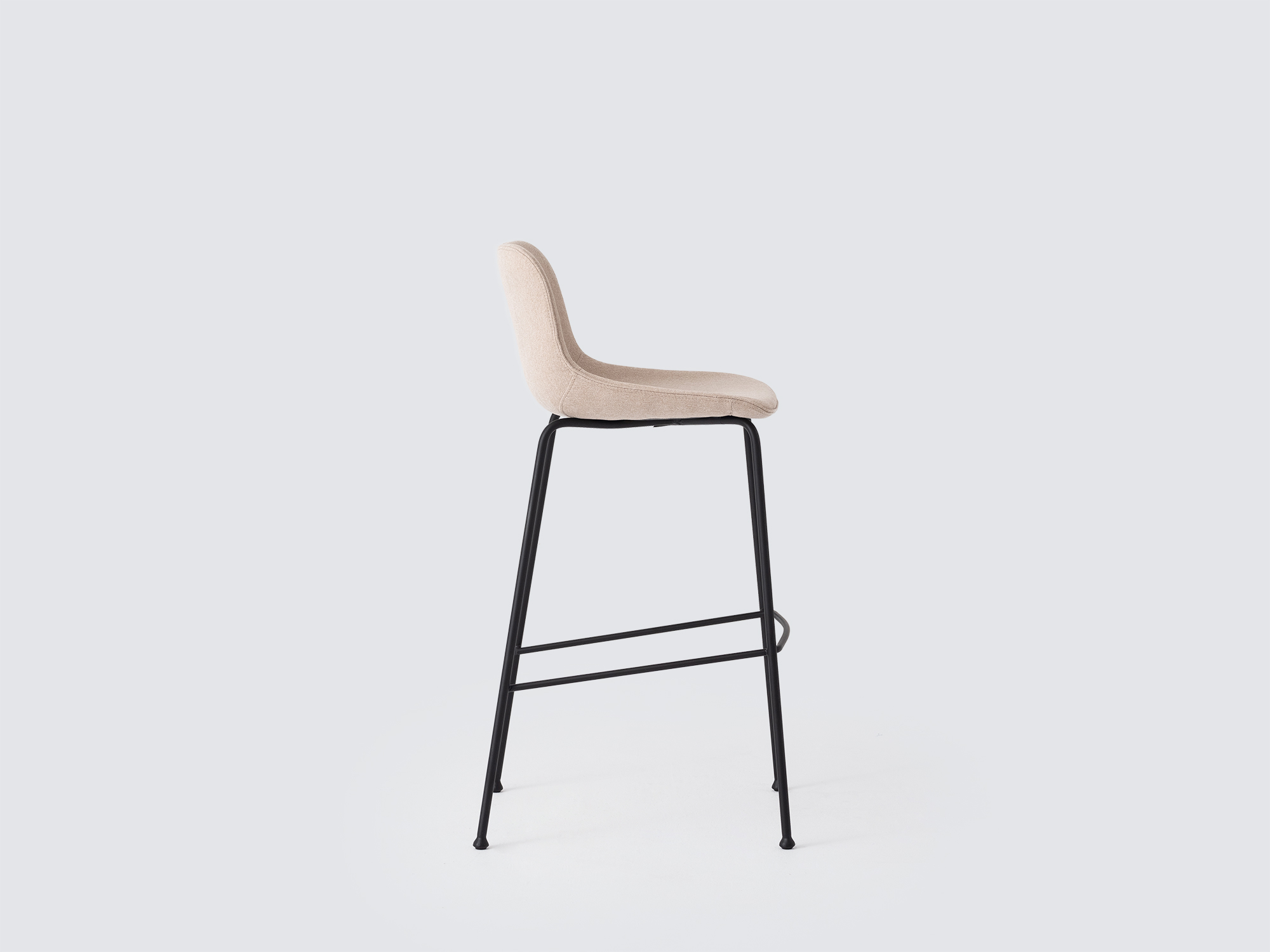 Side view of the Oles counter height bat stool with beige fabric seat