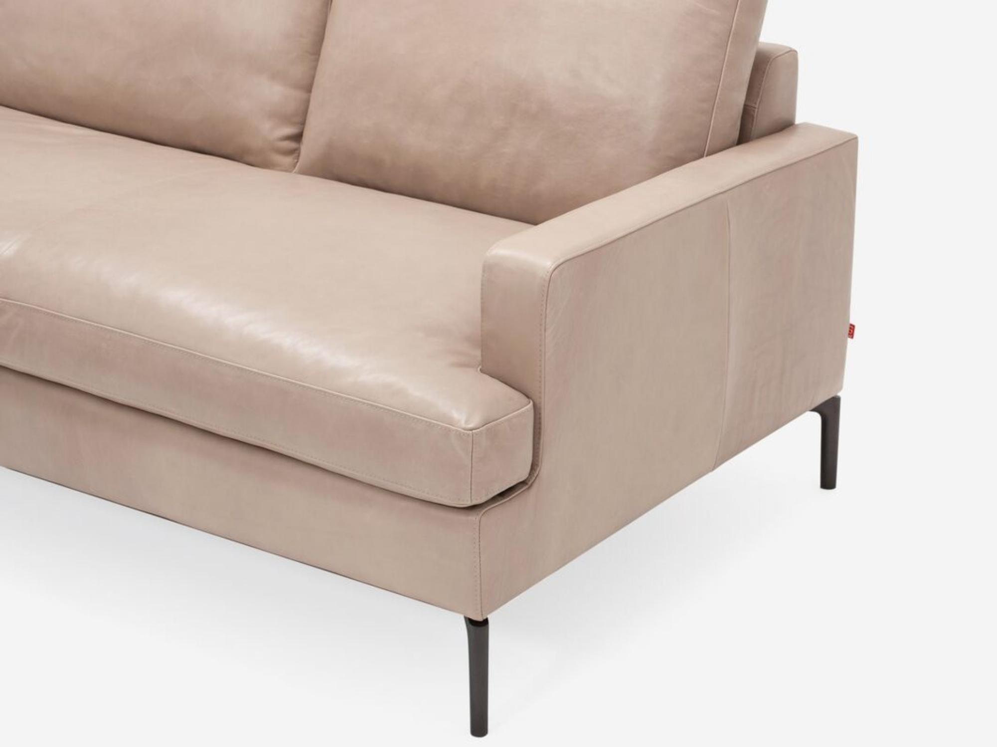 Detail view of the right arm of the mid century modern Eve Sofa in beige leather