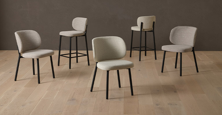 Fabric chairs and bar stools are displayed in a studio setting. Link to Lilly product listing page