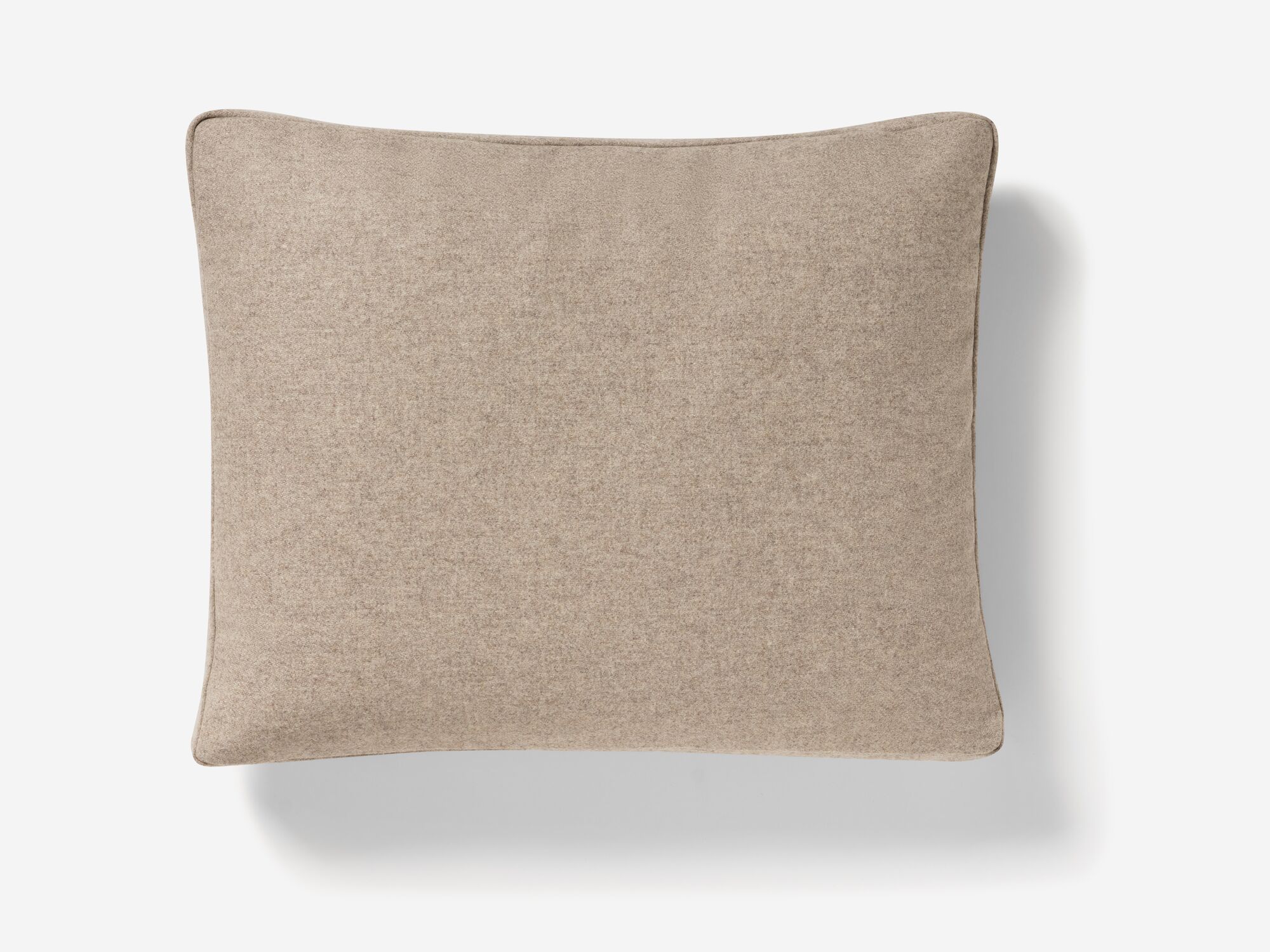 Overhead view of beige throw pillow