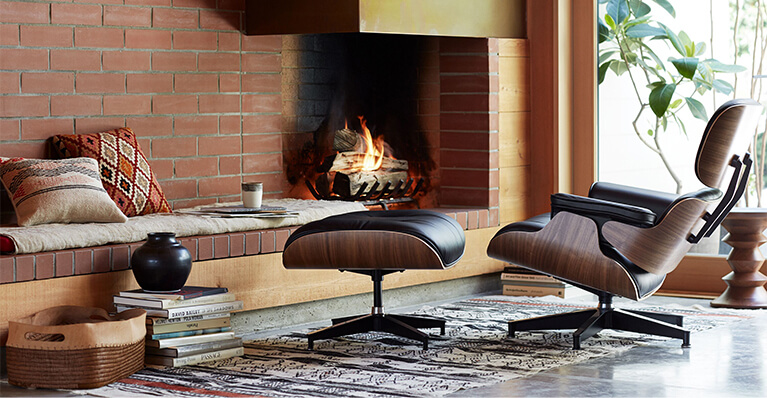 Herman Miller iconic eames lounge chair and ottoman are displayed in detail in a living room. Link to herman miller sale page