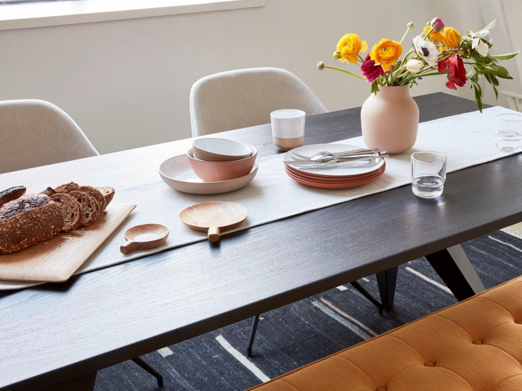 White pasta bowls with stoneware dishes on black modern dining table