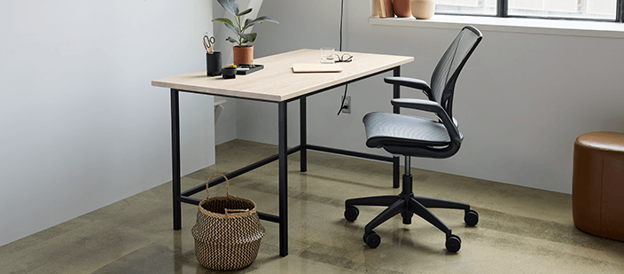 Ergonomic computer chair by desk in modern home office