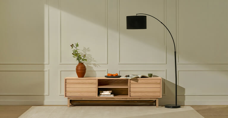 An oak veneer media unit is shown against a white wall. Link to media storage category