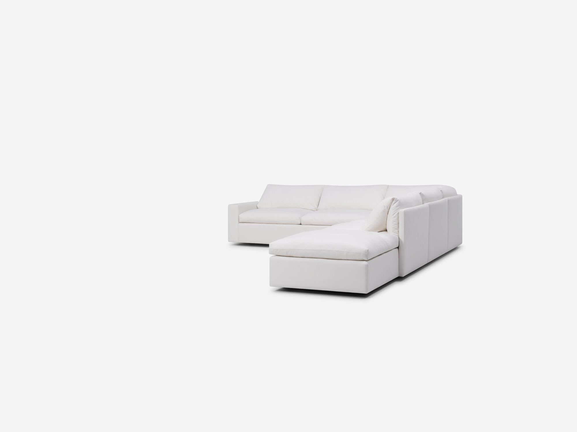 Right angle view of white sectional sofa with right hand chaise