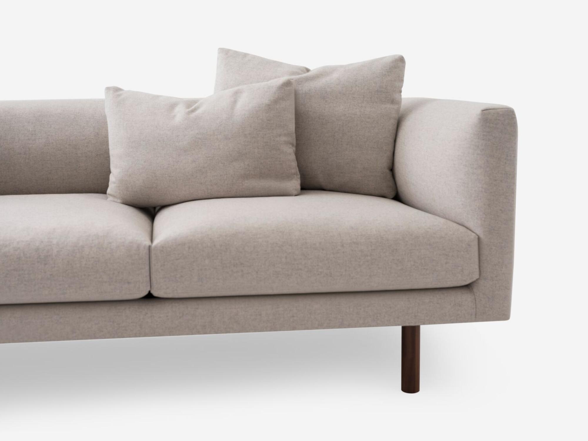 Detail view of the Replay modern sectional upholstered in beige fabric