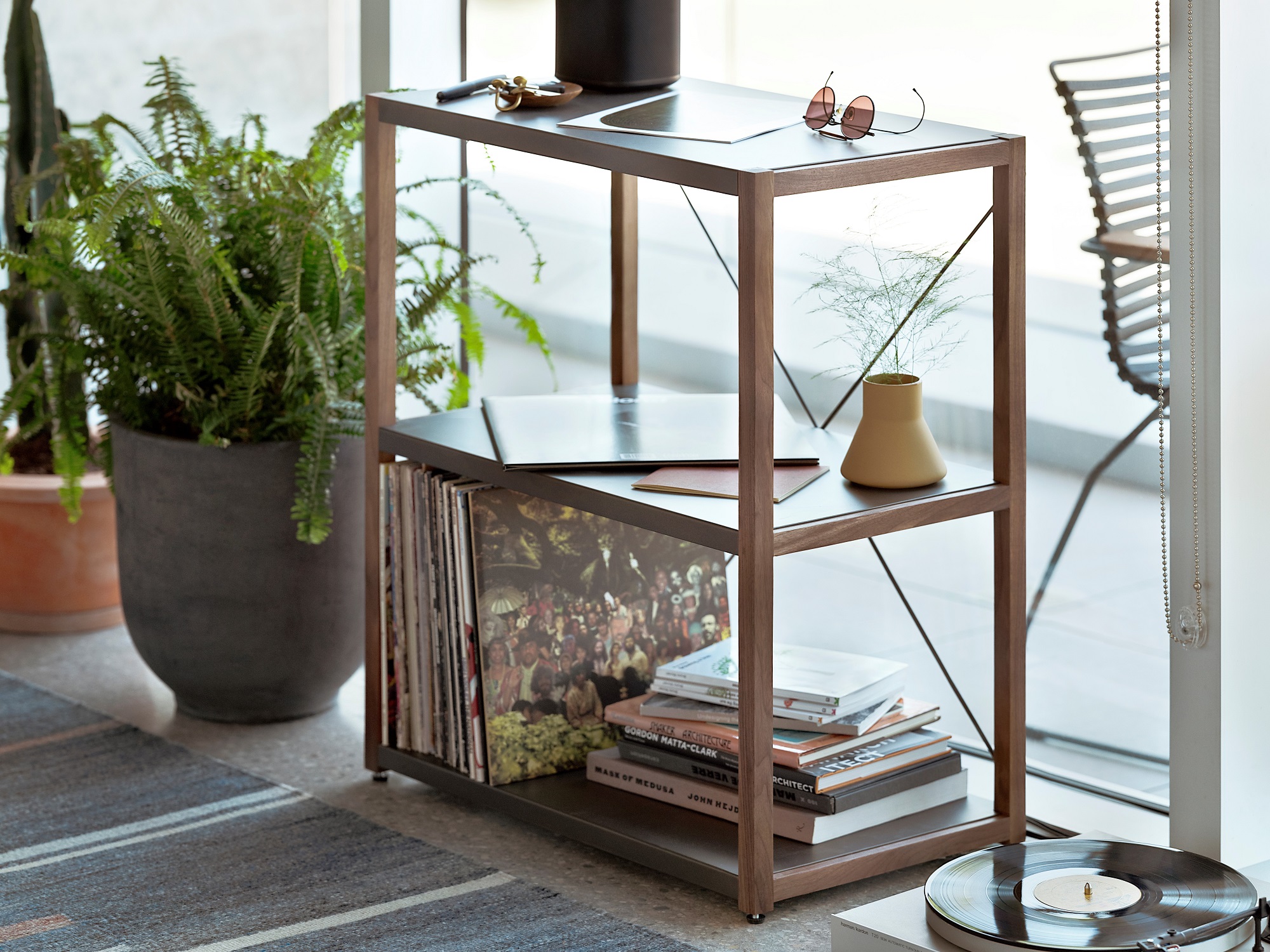 Walnut and charcoal open bookcase in front of large window