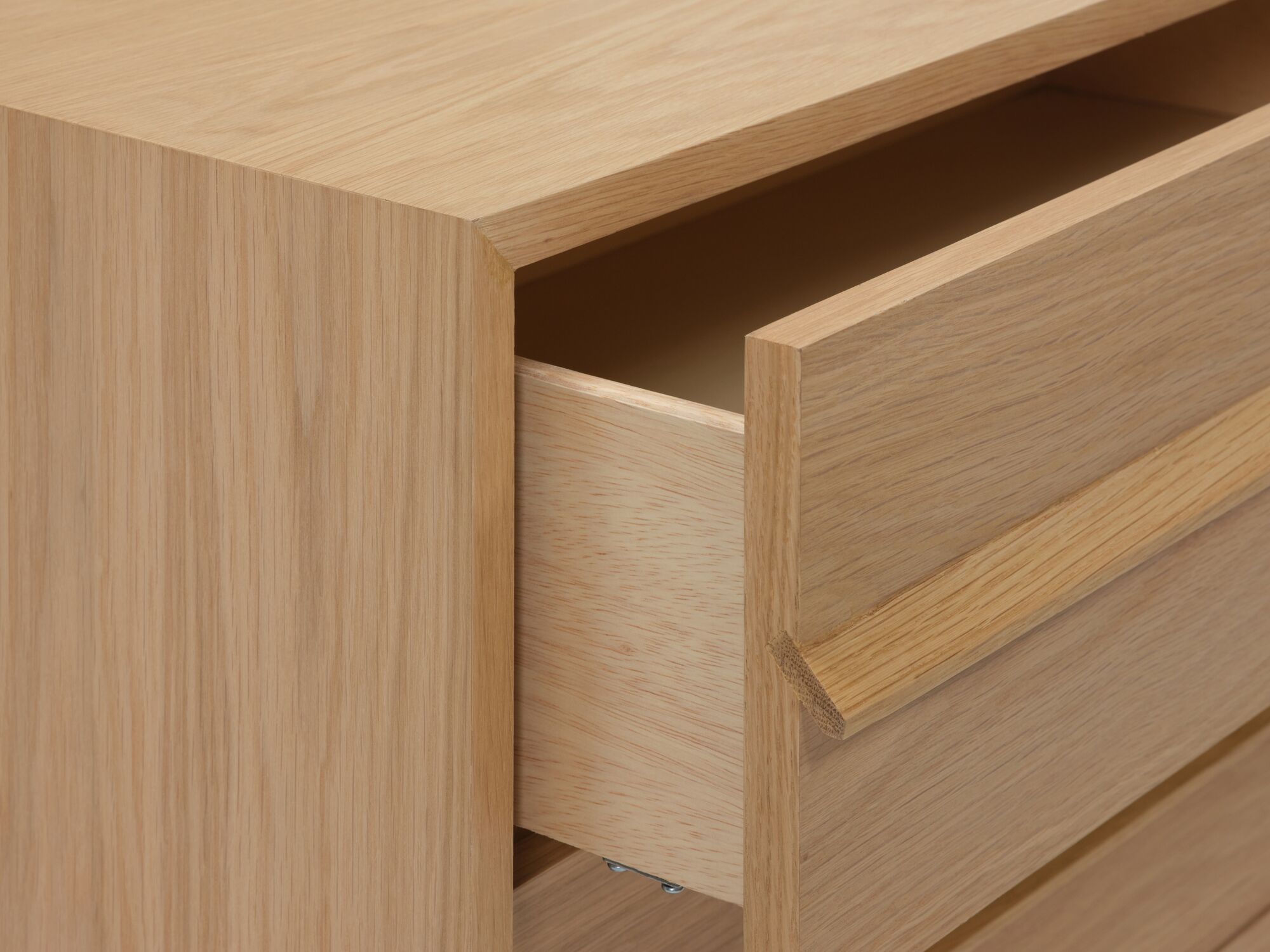 Detail view of the Marcel mid century modern dresser in oak with drawer open