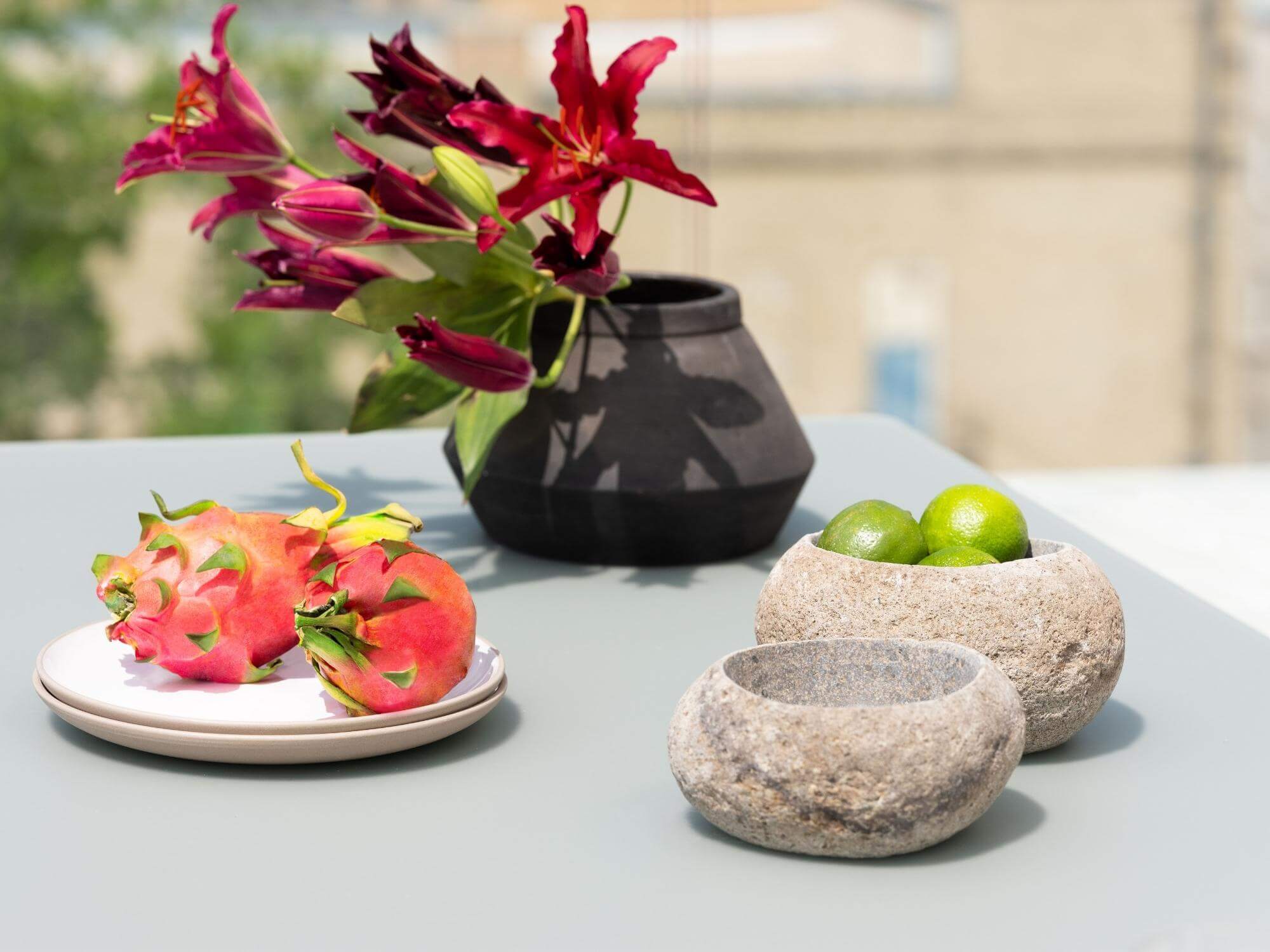 Fruit in stoneware bowl on grey table