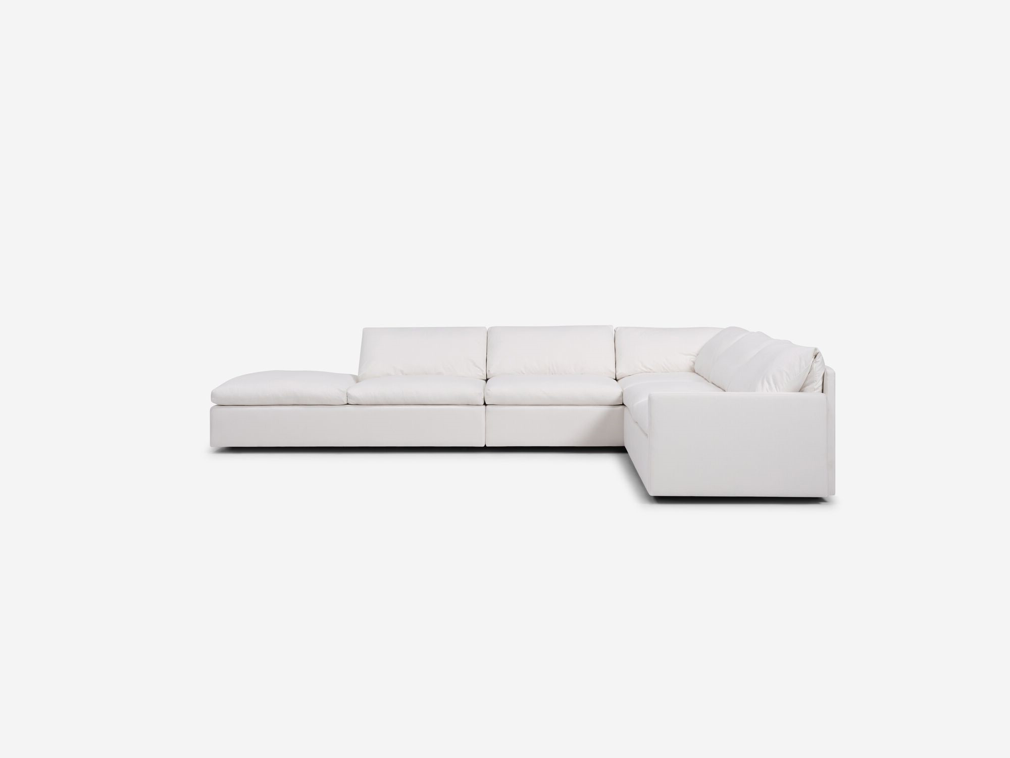 White sectional sofa with narrow arms and left hand chaise side view