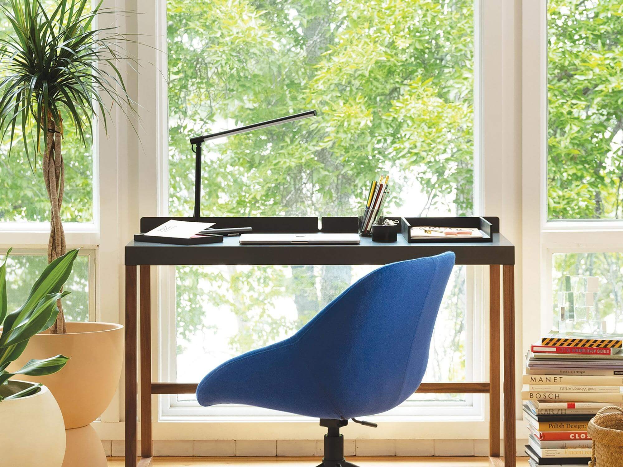 Modern slim office table lamp over working desk with chair