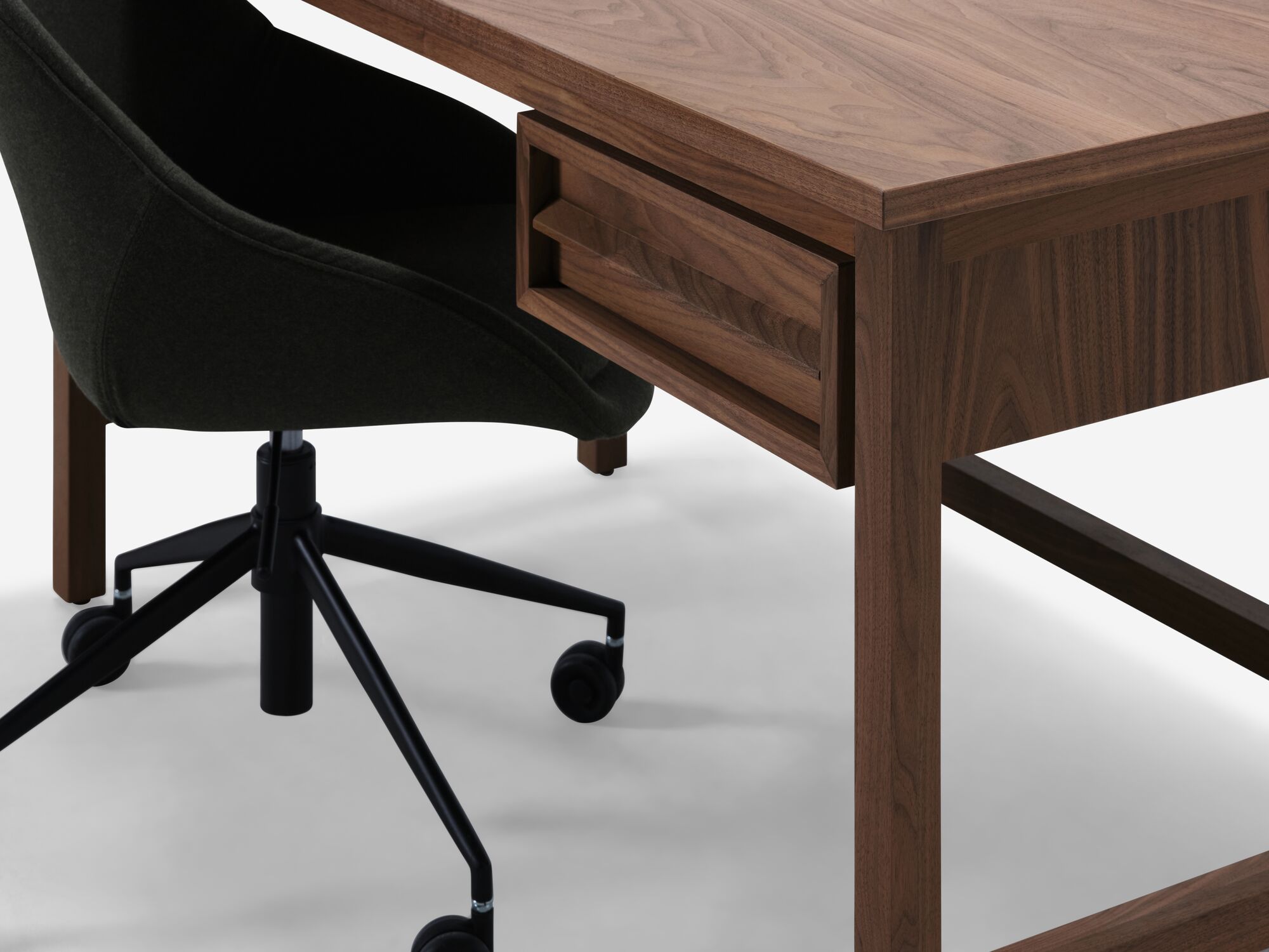 Detail view of walnut desk with office chair