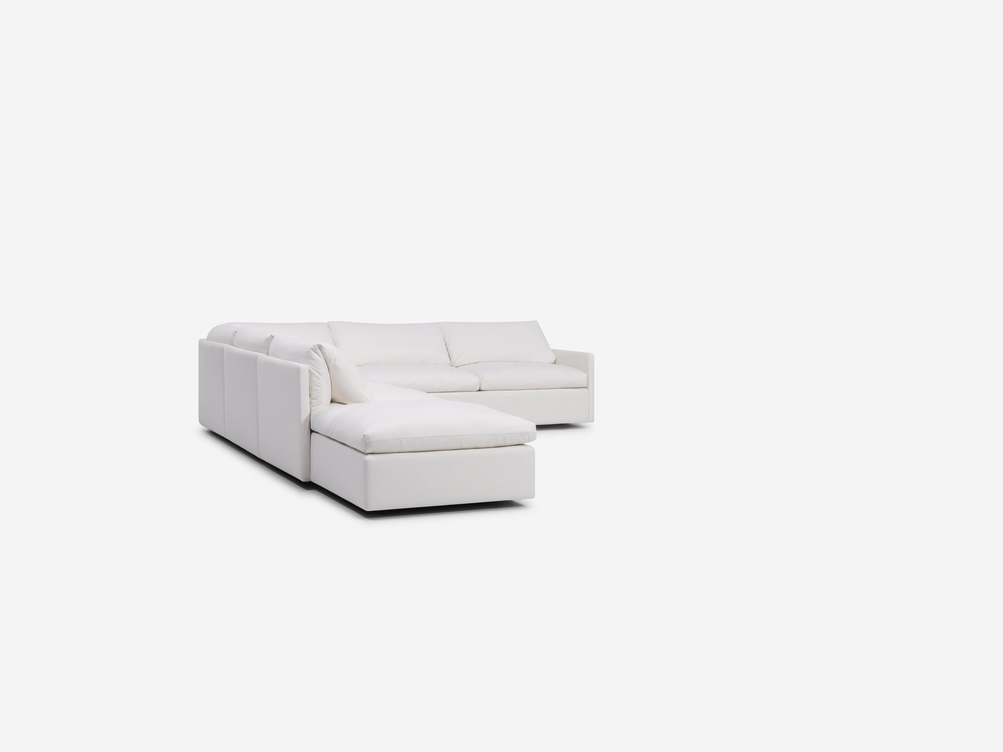 Right angle view of white sectional sofa with narrow arms and left hand chaise
