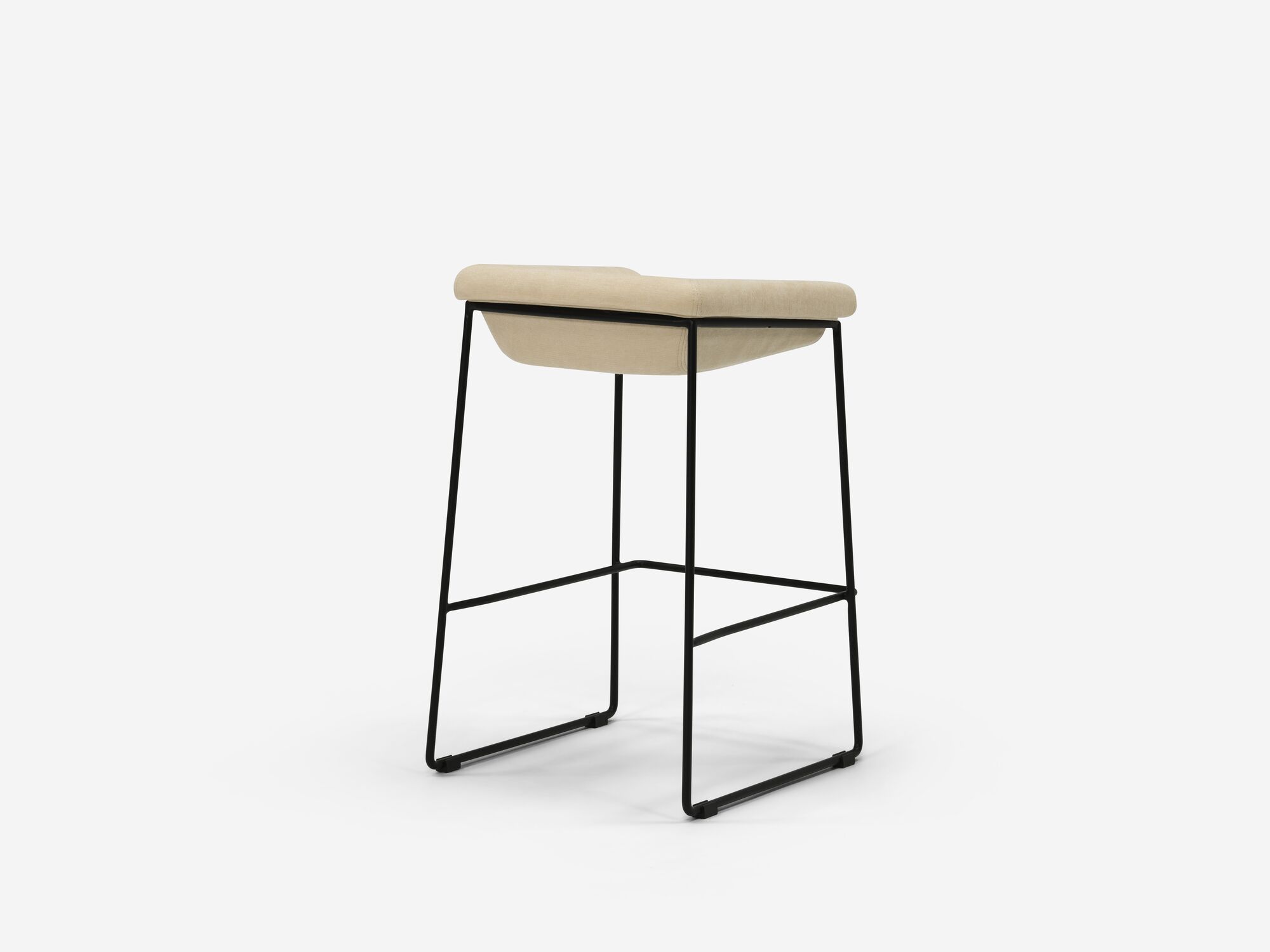 Counter stool with beige seat and black legs back angle view