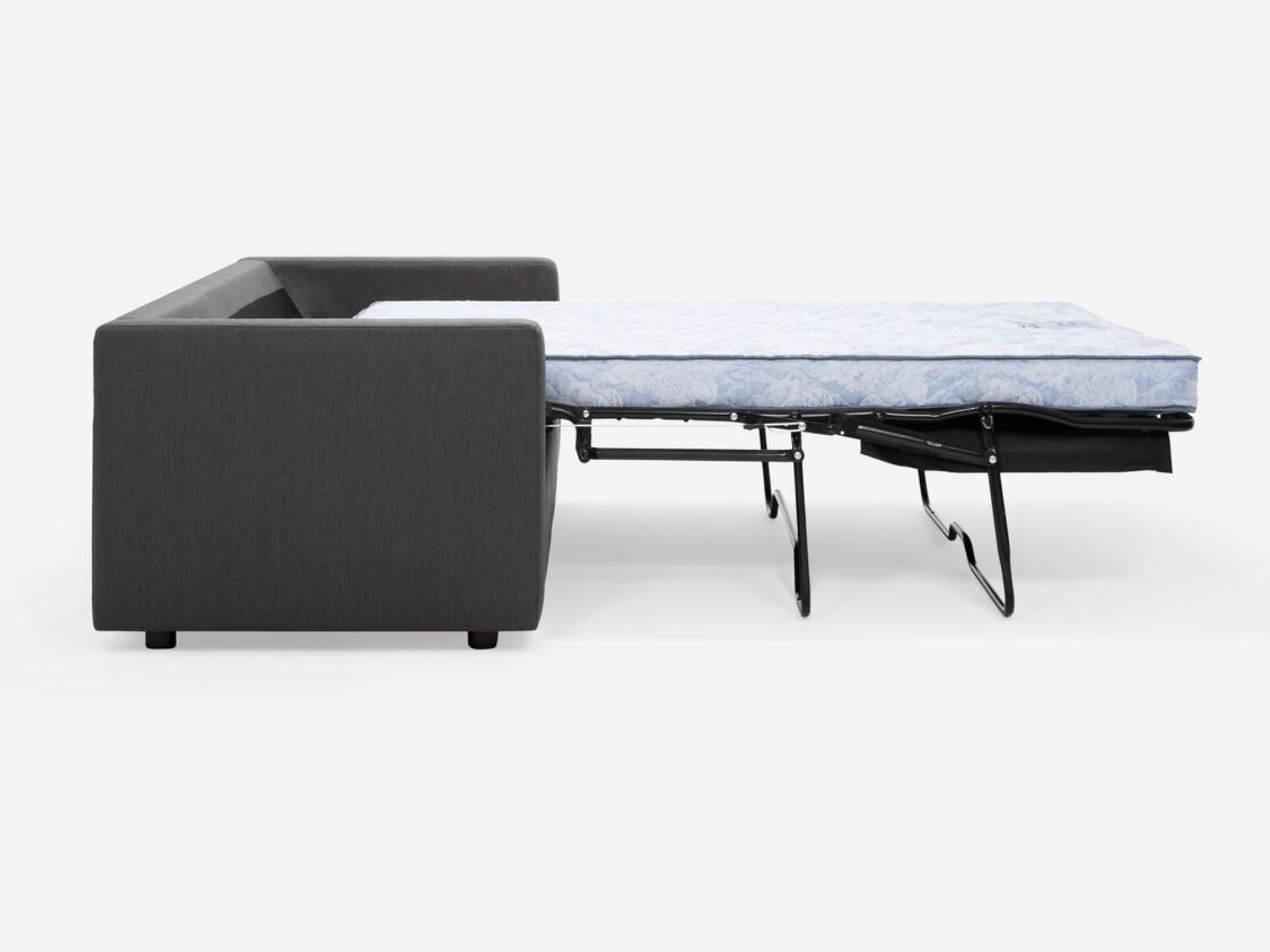 Side view of the Solo sofa bed in dark grey fabric with bed unfolded